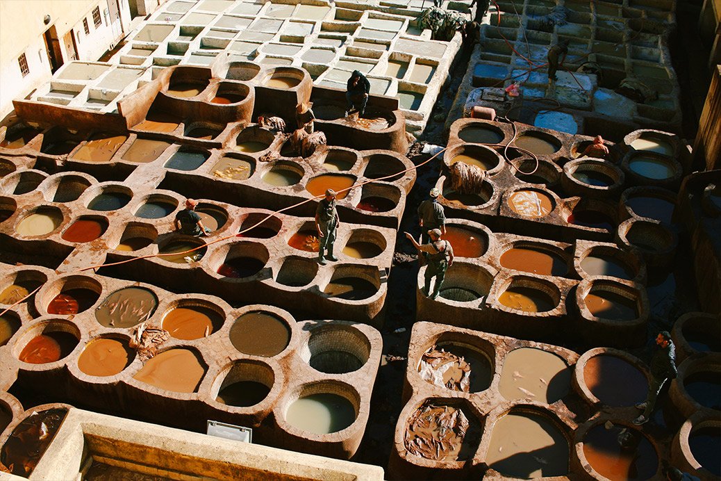 Traditional tannery in Fez, Morocco, with colorful dye vats.